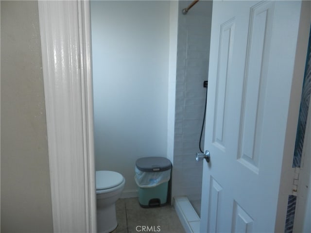 bathroom with tile patterned flooring, toilet, and a shower with shower curtain