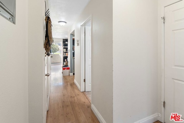 corridor with light hardwood / wood-style flooring