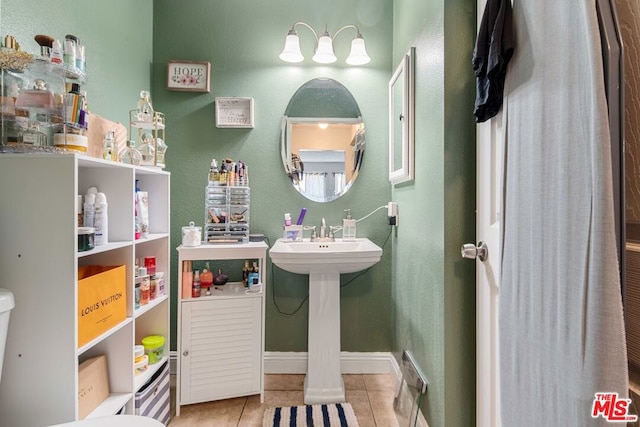 bathroom featuring toilet and tile patterned flooring