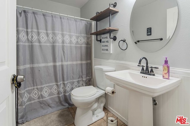 bathroom with sink, tile patterned flooring, walk in shower, and toilet