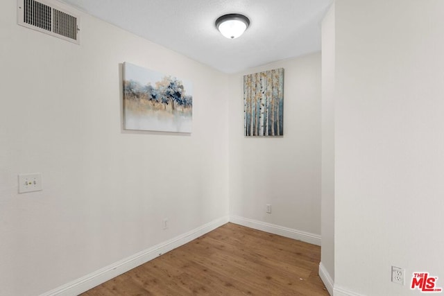 spare room featuring hardwood / wood-style flooring