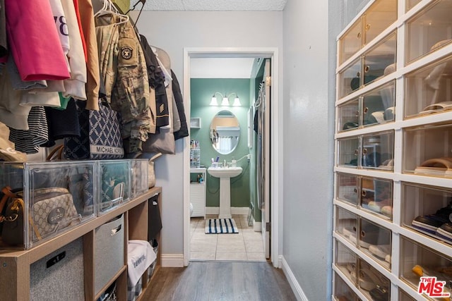 spacious closet featuring dark hardwood / wood-style flooring