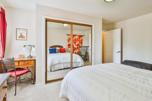 bedroom with a closet and light colored carpet