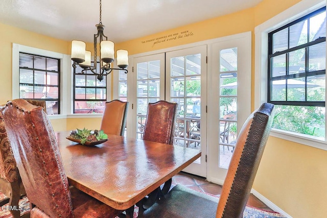 tiled dining area with plenty of natural light and a chandelier