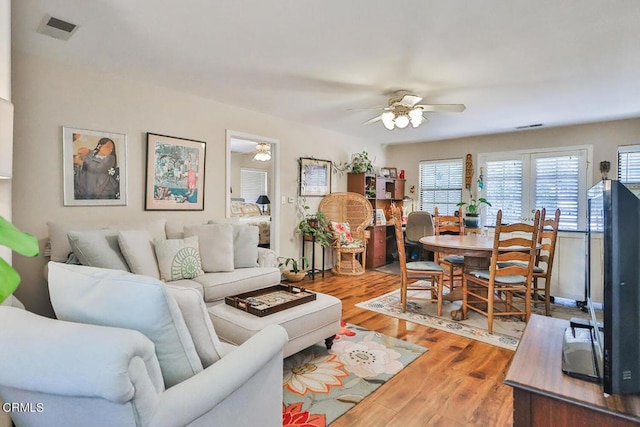 living room with hardwood / wood-style floors and ceiling fan