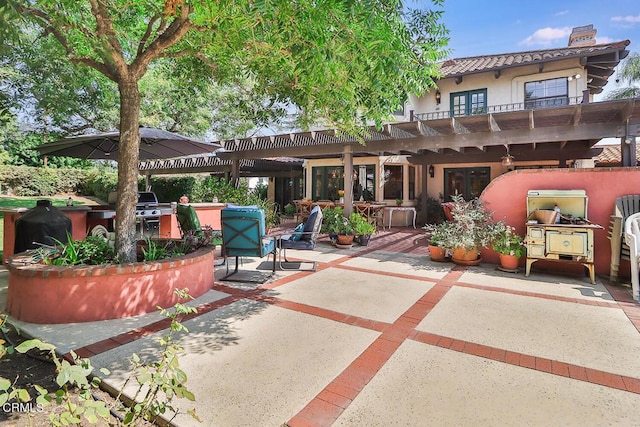 view of patio featuring a pergola and exterior kitchen