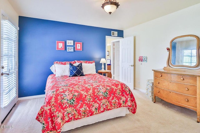 carpeted bedroom featuring multiple windows