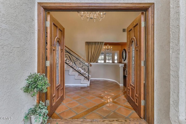 interior space with tile patterned floors and an inviting chandelier