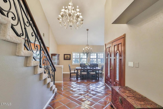 entryway featuring tile patterned floors, a high ceiling, and an inviting chandelier