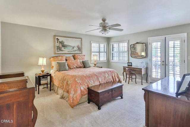 bedroom with access to exterior, french doors, light colored carpet, and ceiling fan