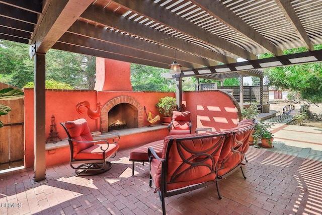 view of patio with a pergola and an outdoor brick fireplace