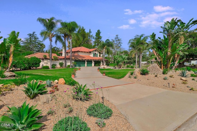 view of front of property with a garage and a front lawn