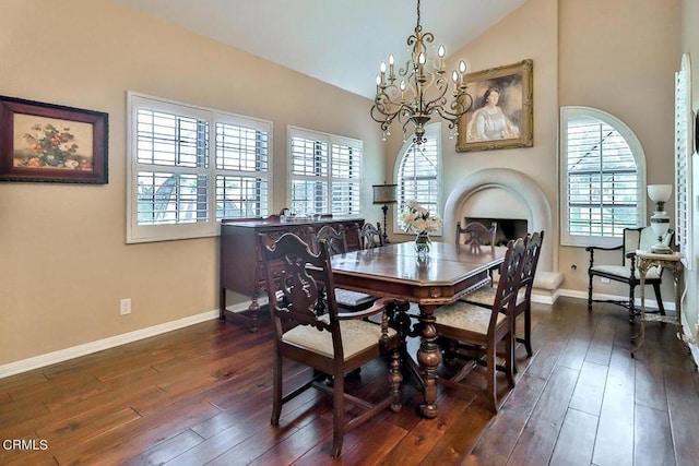 dining area with a notable chandelier, dark hardwood / wood-style floors, and lofted ceiling