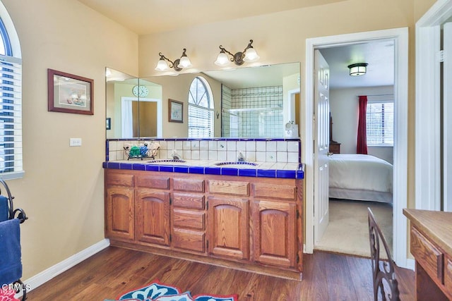 bathroom with vanity, wood-type flooring, and walk in shower