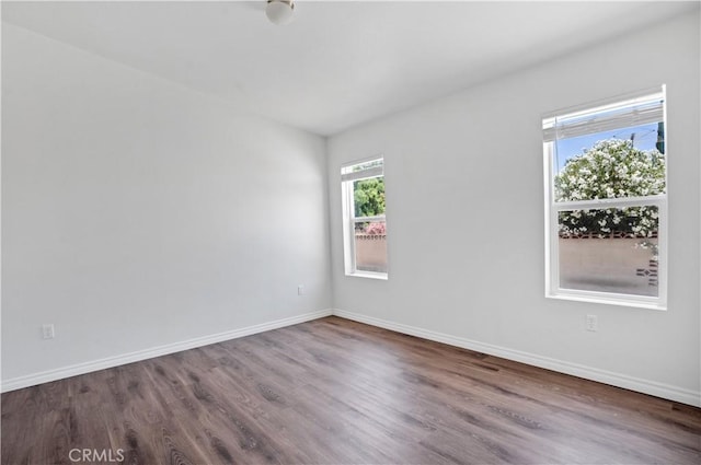 unfurnished room with wood-type flooring