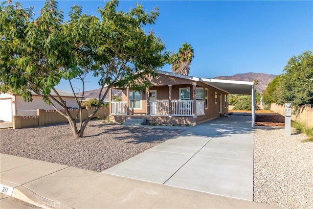 view of front of property featuring a carport, a mountain view, and a porch