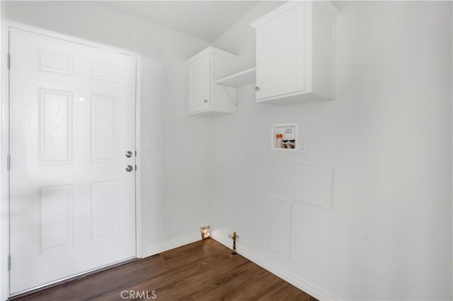 clothes washing area featuring cabinets, gas dryer hookup, dark wood-type flooring, and hookup for a washing machine