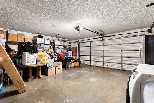 garage with freestanding refrigerator, washer / dryer, and a garage door opener
