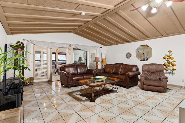 living area with lofted ceiling with beams, a ceiling fan, and light tile patterned floors