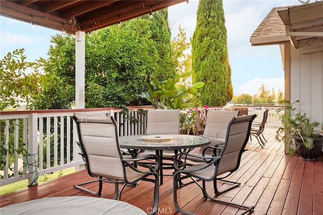 wooden terrace featuring outdoor dining area