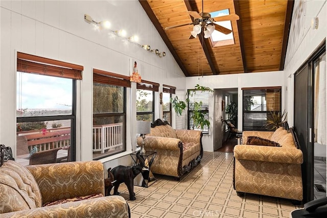 sunroom featuring ceiling fan, wooden ceiling, and lofted ceiling with skylight