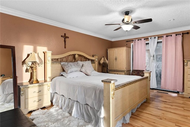 bedroom with crown molding, light wood-style flooring, and a textured ceiling