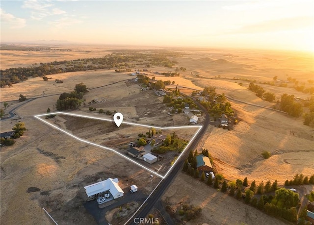 aerial view at dusk featuring a rural view