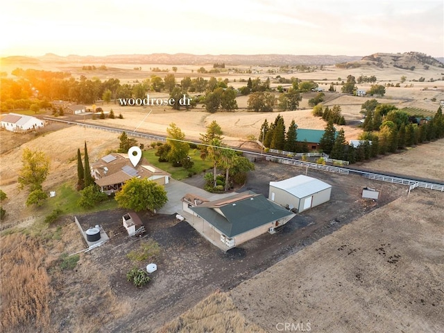 aerial view at dusk featuring a rural view