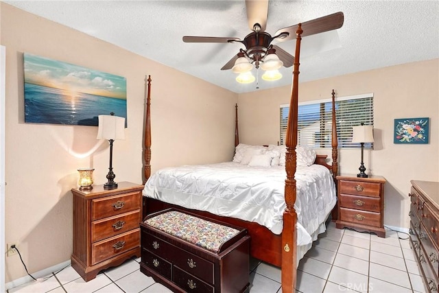 bedroom featuring ceiling fan, a textured ceiling, and light tile patterned floors