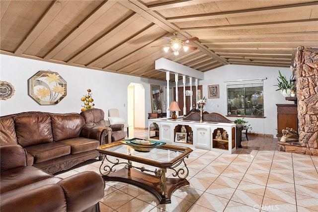living area featuring vaulted ceiling with beams and light tile patterned floors
