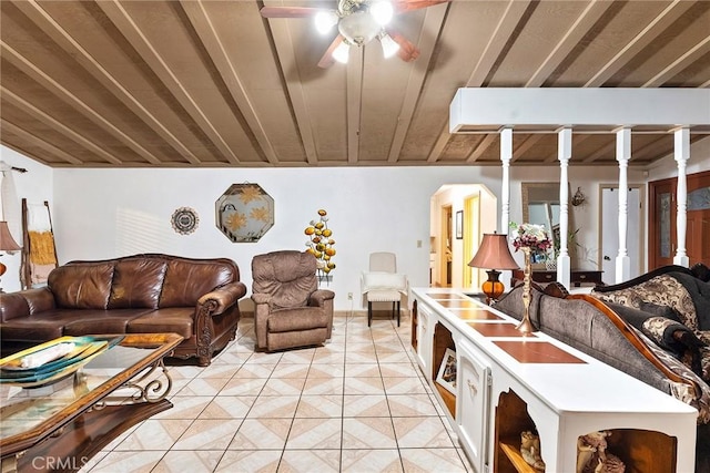 living area with light tile patterned flooring and ceiling fan