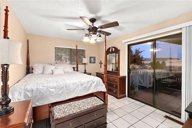 bedroom featuring access to outside, a textured ceiling, light tile patterned flooring, ceiling fan, and visible vents