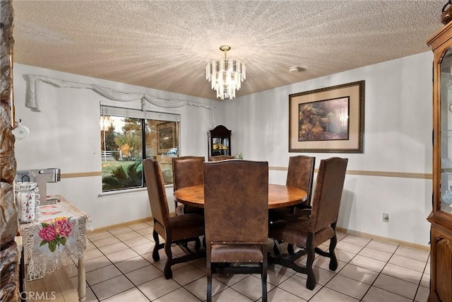 dining room with a textured ceiling, an inviting chandelier, and light tile patterned floors