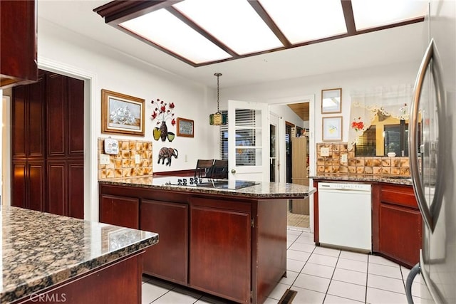 kitchen with black electric stovetop, light tile patterned floors, white dishwasher, and stainless steel fridge