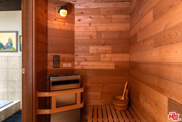 view of sauna featuring wooden walls