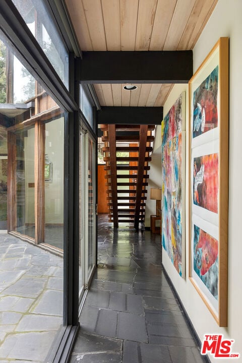 hallway with wood ceiling and beam ceiling