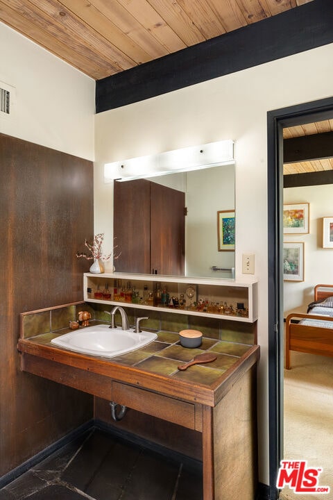 bathroom with wood ceiling and sink