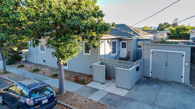 view of front of home with a shed