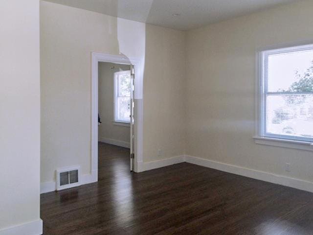 unfurnished room featuring dark hardwood / wood-style floors