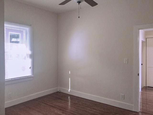 unfurnished room featuring ceiling fan and dark hardwood / wood-style flooring