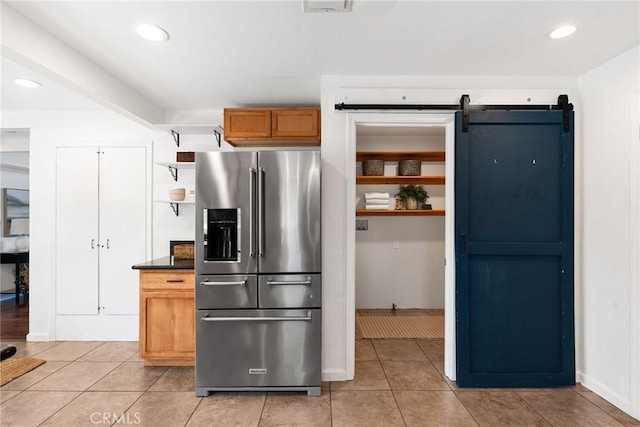 kitchen featuring light tile patterned floors and high quality fridge