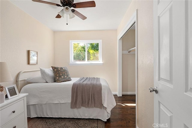 bedroom with ceiling fan, a closet, and dark wood-type flooring