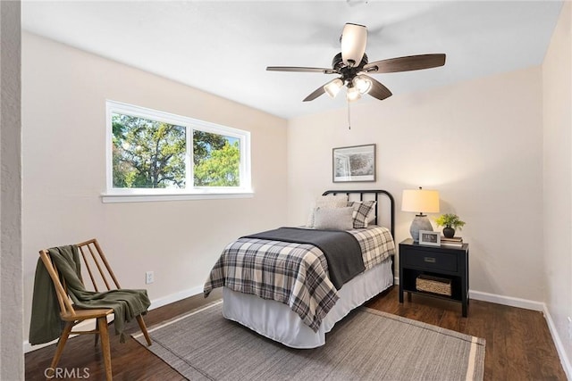 bedroom with ceiling fan and dark hardwood / wood-style floors