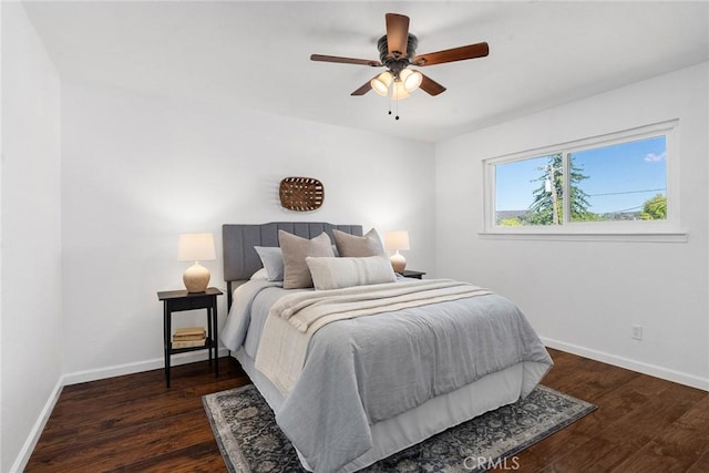 bedroom with ceiling fan and dark hardwood / wood-style flooring