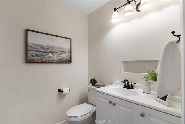 bathroom with toilet and vanity