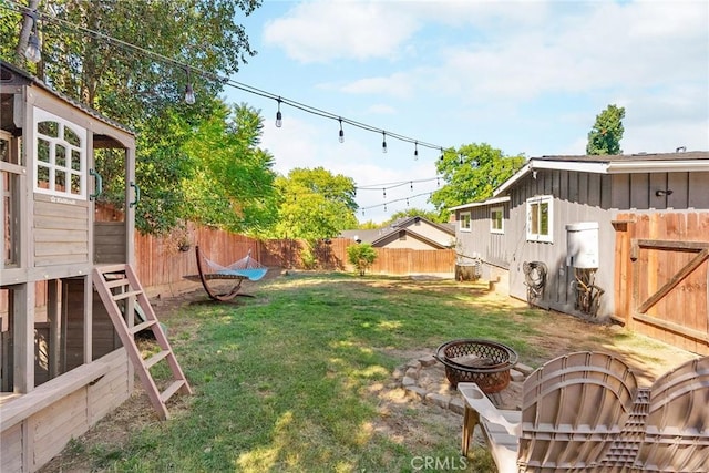 view of yard with a fire pit