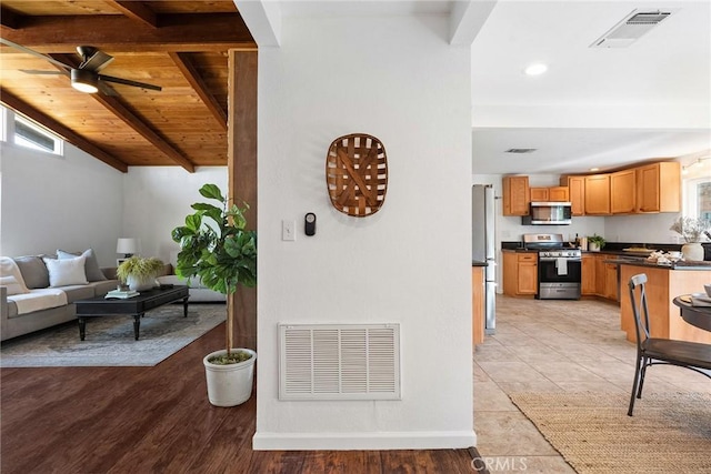 living room with ceiling fan, wooden ceiling, and beamed ceiling