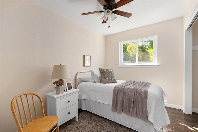 bedroom with ceiling fan and dark hardwood / wood-style flooring