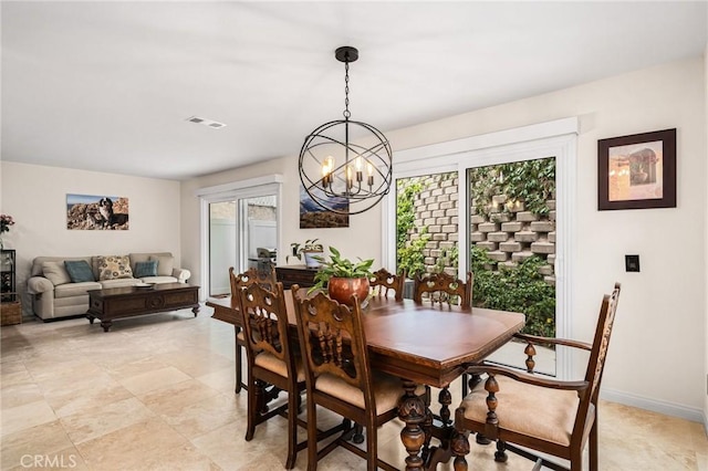 dining space featuring a chandelier, a healthy amount of sunlight, visible vents, and baseboards