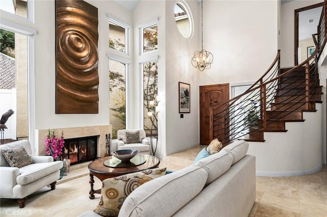 living room featuring a towering ceiling and a notable chandelier